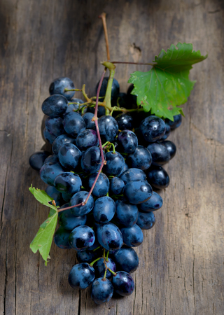 Bunch of red grapes on wooden table backgroundの写真素材