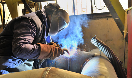 woman welder welding with mig-mag methodの写真素材