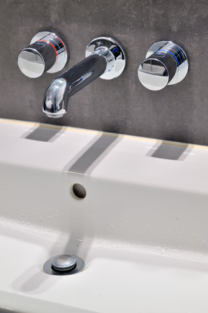 Modern faucet and sink in the bathroomの写真素材