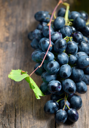 Bunch of red grapes on wooden table backgroundの写真素材