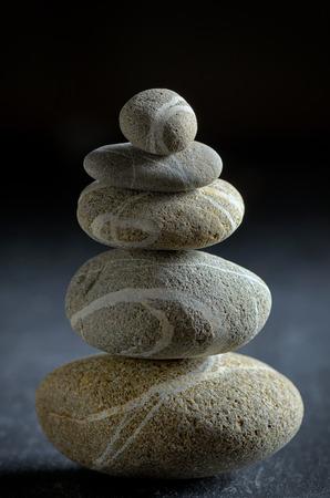 stack of  pebble stones on black backgroundの写真素材