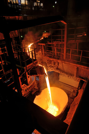 pouring molten steel in steel ladleの写真素材