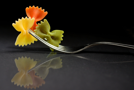 Reflexion of pasta farfalle on a forkの写真素材