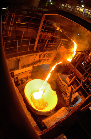 Hot steel pouring in ladle car train in steel plantの写真素材