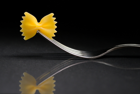 Reflexion of pasta farfalle on a forkの写真素材