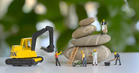 Pebbles stack and figurines workersの写真素材