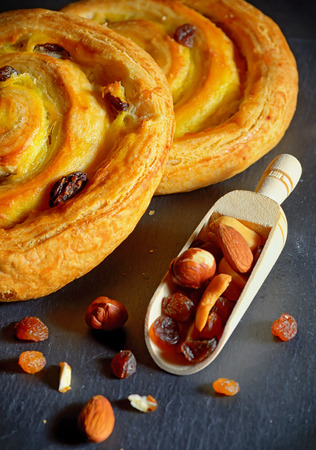 Round shape fresh croissant filled with vanilla cream and raisinsの写真素材