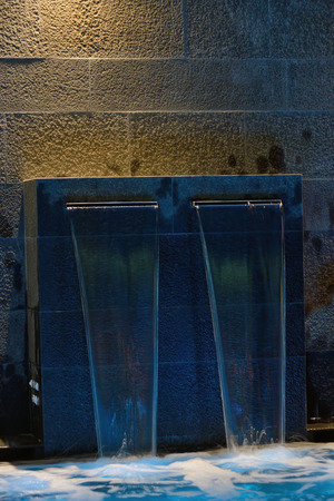 Empty Swimming pool with waterfall jet and hot tubの写真素材