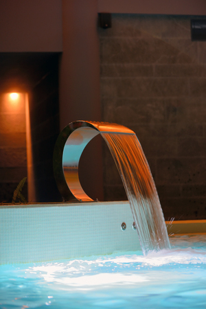 Relaxation pool in spa with waterfallの写真素材