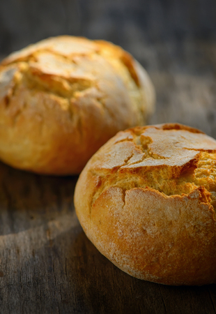 traditional homemade round bread on wooden tableの写真素材