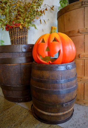 Halloween pumpkin head jack lantern on wooden barrelの写真素材
