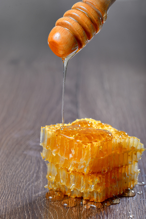honey runs a honey dipper down isolatedの写真素材