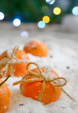Christmas composition with mandarins in snow の写真素材