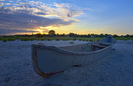Beautiful sunset with fishing boatの写真素材