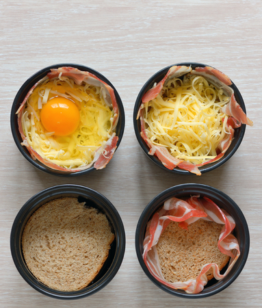 fried eggs, bread and bacon in a porcelain panの写真素材