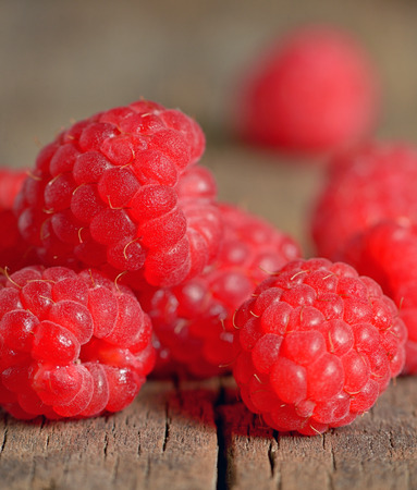 Ripe and fresh raspberry on wooden tableの写真素材