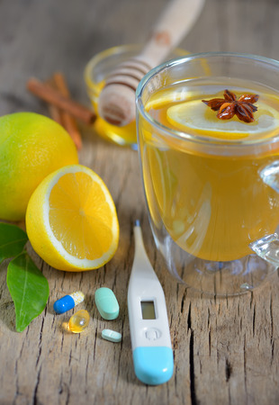 Thermometer and cup of tea, pills,teaの写真素材