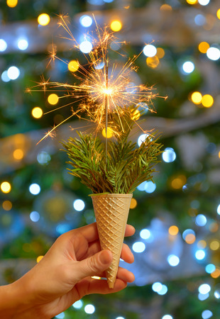 Bright festive Christmas sparkler in ice cream waffleの写真素材
