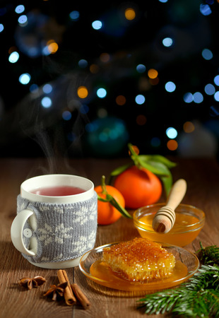 cup of hot tea with honey and winter spicesの写真素材