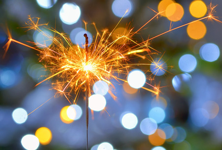 Bright festive Christmas sparkler and lightsの写真素材