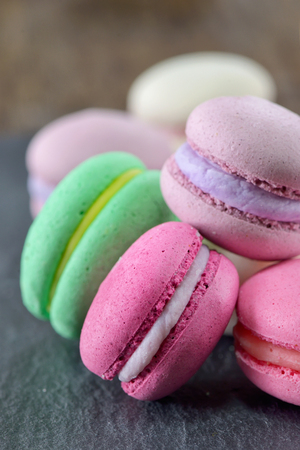 Colorful macaroons on ardesia stone plateの写真素材