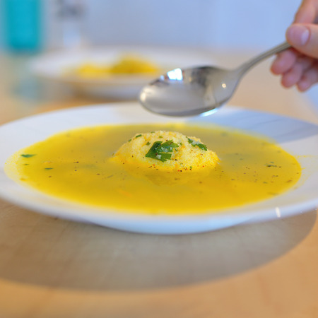 Soup with dumplings on tableの写真素材