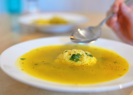 Soup with dumplings on tableの写真素材