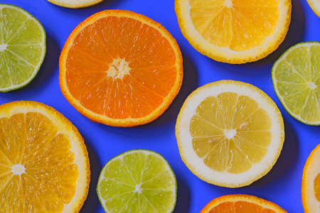 Blue background with citrus fruit slicesの写真素材