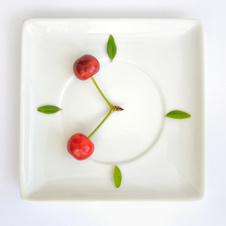 Natural clock concept from cherry fruitの写真素材