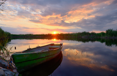 Fisherman boat on Danube Delta at sunsetの写真素材