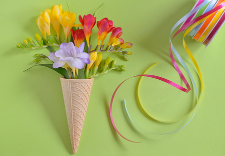 Freesias flowers in ice cream waffles and ribbonsの写真素材