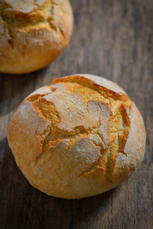 traditional homemade round bread on wooden tableの写真素材