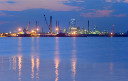 Industrial Petrochemical plant and sea in night timeの写真素材