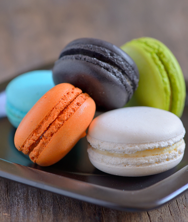 french colorful macarons on wooden tableの写真素材