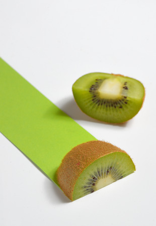 Kiwi fruit sliced and green path on white backgroundの写真素材