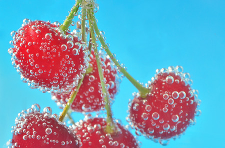 Cherry and bubbles in waterの写真素材