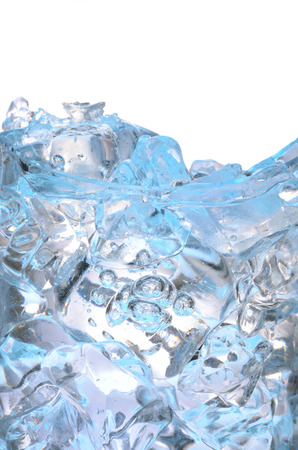 Glass with frozen ice cubes isolated on whiteの写真素材