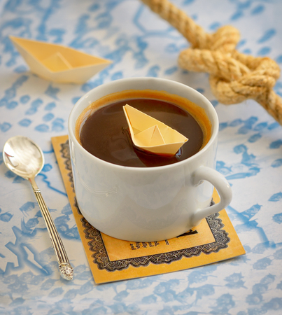 coffee cup and paper boat on mapの写真素材