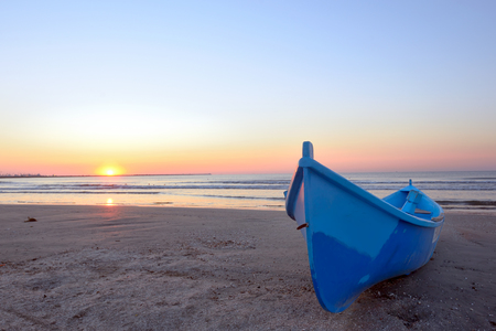Fishing boat and sunrise at black seaの写真素材