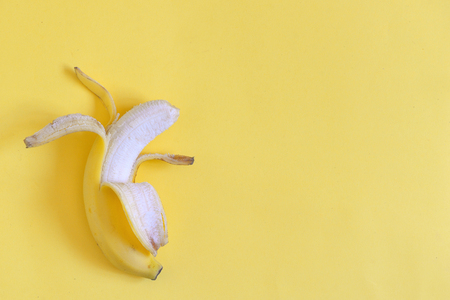 Ripe open banana on yellow backgroundの写真素材