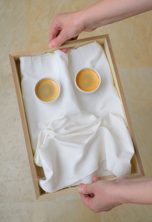 Espresso coffee smiley face on plateの写真素材