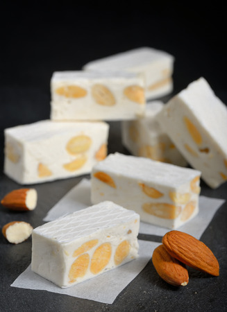 White nougat with almonds on black ardesia plateの写真素材