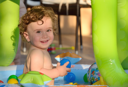 Laughing little girl swimming in the small poolの写真素材