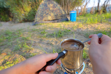 Making coffee on campfire in morning timeの写真素材