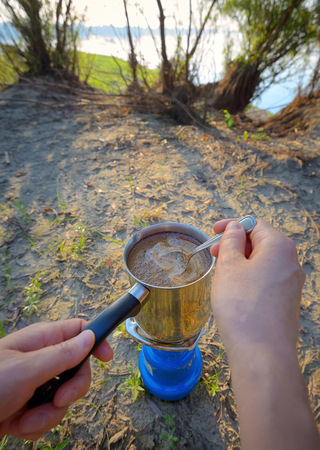 Making coffee on campfire in morning timeの写真素材
