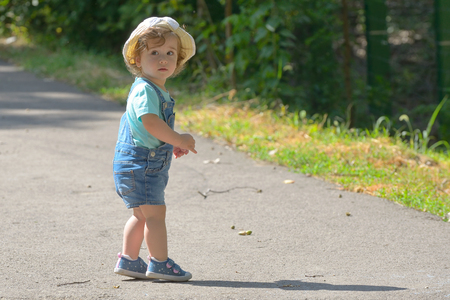 Little girl alone on street in summerの写真素材