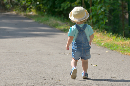 Little girl alone on street in summerの写真素材