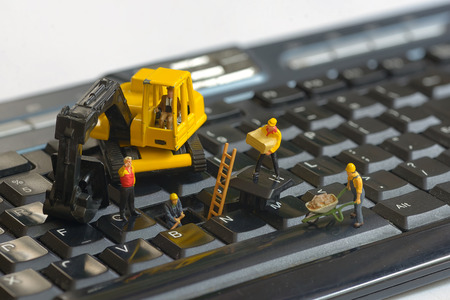 Workers figurnes repairing keyboardの写真素材