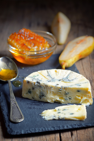 Blue Cheese and honey on ardesia plateの写真素材
