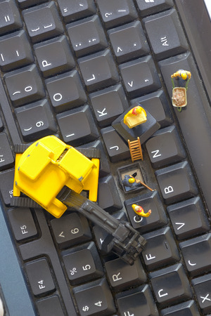 Workers figurnes repairing keyboardの写真素材